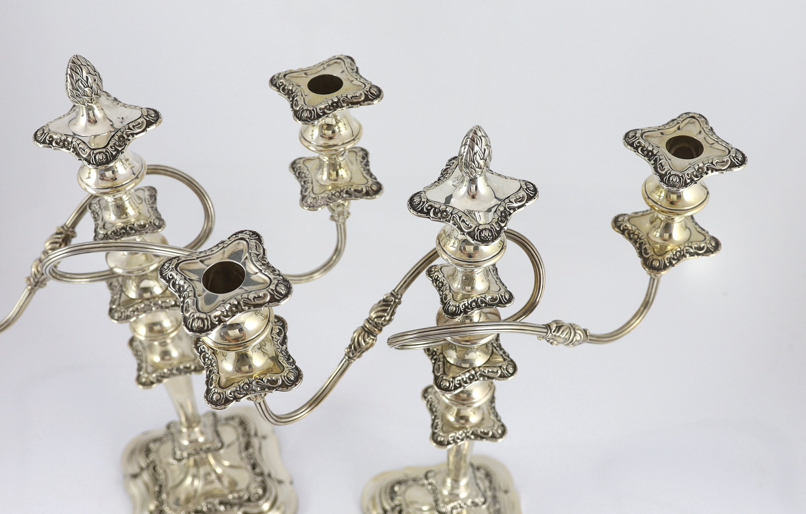 A pair of George VI silver two branch three light candelabra by George Howson